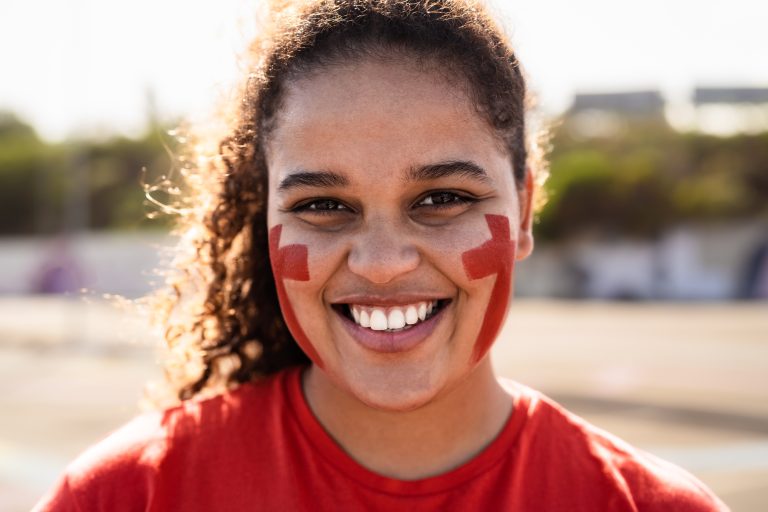 African football fan having fun supporting her favorite team - Sport entertainment concept