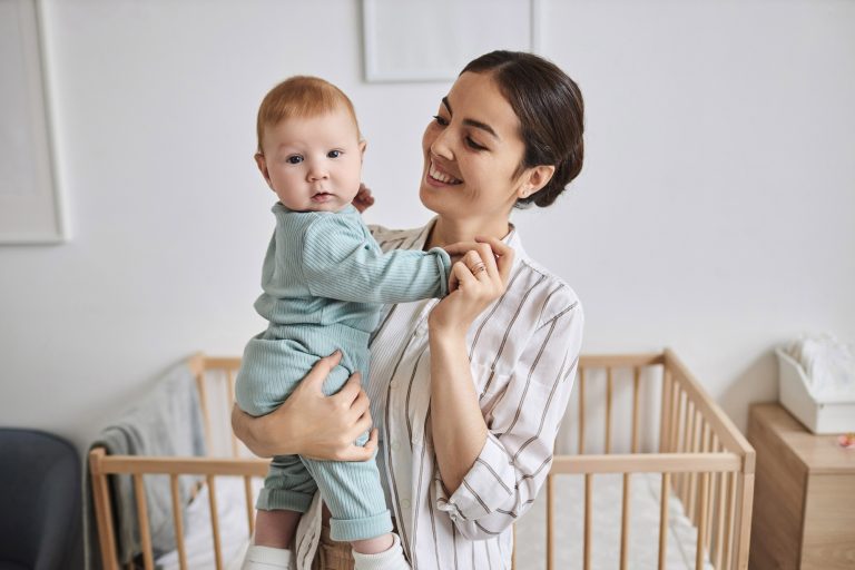 Happy Young Mother Holding Baby
