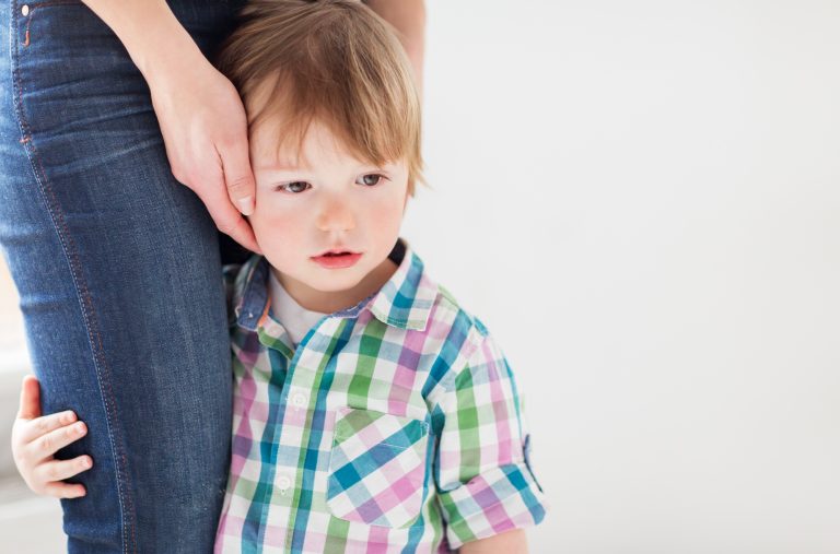 sad little boy holding to mother