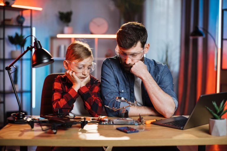 Thoughtful father with son looking at broken display card